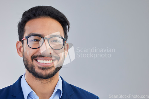 Image of Portrait, happy and excited businessman in studio with glasses, smile and confident on grey background space. Face, isolated and young mexican entrepreneur pose empowered, professional and handsome