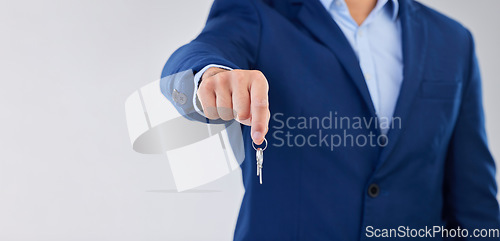 Image of Key, real estate and mockup with a property agent in studio on a white background for the sale of a home. Mortgage, investment and opportunity with the hand of a realtor holding keys to an apartment