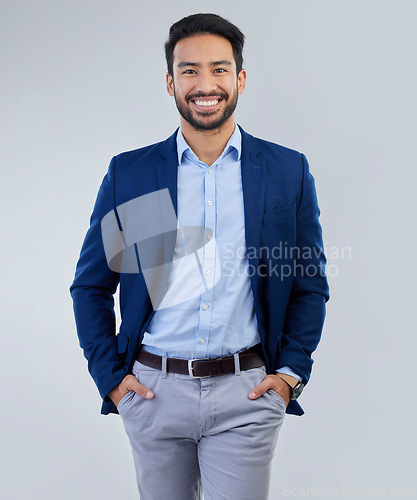 Image of Business man, smile and fashion portrait in studio as corporate worker or CEO while happy. Face of asian entrepreneur person on isolated white background with pride, success and hands in pocket