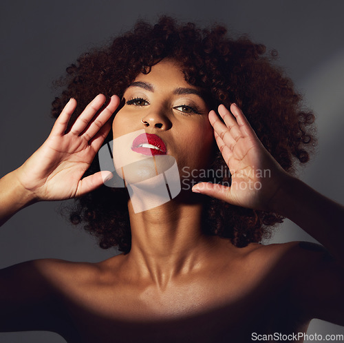 Image of Black woman, red lipstick and spotlight with beauty and makeup in portrait, hands frame face on studio background. Cosmetics, creative and aesthetic with beautiful female, cosmetology and art deco