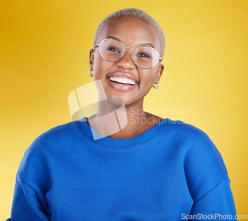 Image of Young black woman, studio portrait and smile with glasses, eye health or fashion frame by yellow background. African, student girl or model for happiness, youth or beauty with eyes, vision and happy