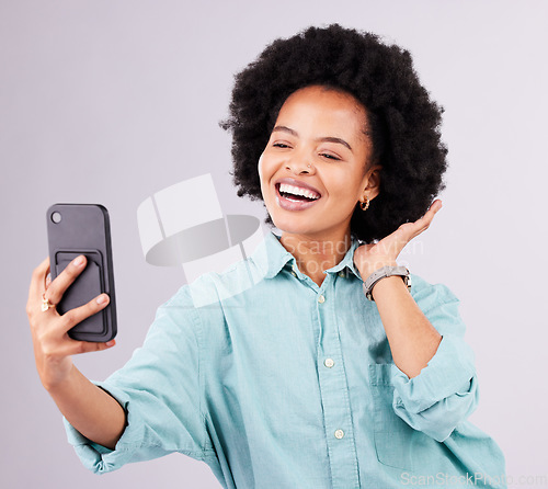 Image of Black woman, selfie and afro with smile in studio with technology, social media and funny by gray background. Girl, model and influencer with profile picture, photography and blog post with happiness