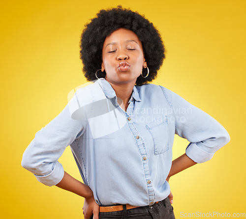 Image of Flirty, attitude and a black woman with a kiss for love isolated on a yellow background. Young, expression and an African girl showing affection, care and a fashionable look on a studio backdrop
