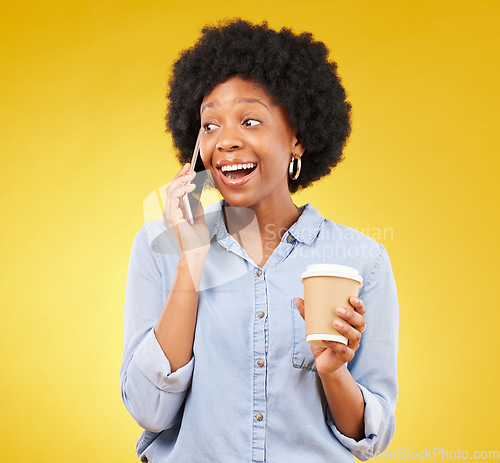 Image of Phone call, happy and black woman with coffee in studio, smile and listening on yellow background. Smartphone, conversation and girl with tea surprised, joke and humor while enjoying speaking online