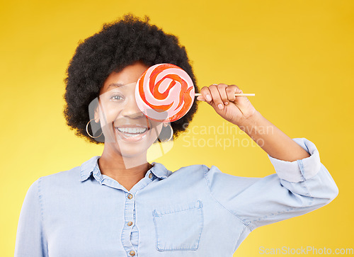 Image of Cover, candy and lollipop with black woman in studio for colorful, cheerful and positive. Young, happiness and dessert with female isolated on yellow background for treats, food and confectionary