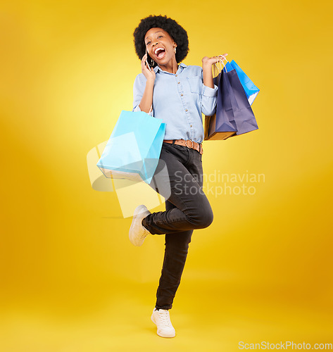 Image of Shopping bag, excited phone call and portrait black woman with sales product, discount fashion deal or mall store present. Talking, designer gift and happy customer chat isolated on yellow background