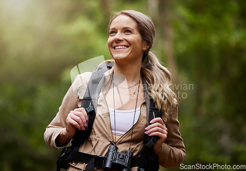 Image of Hiking, smile and woods with a woman outdoor, walking in nature or the wilderness for adventure. Freedom, location and forest with an attractive young female hiker taking a walk in a natural park