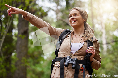 Image of Hiking, pointing or girl in nature, forest or wilderness for a happy trekking adventure with freedom. Excited woman or hiker walking in a natural park or woods for exercise or holiday vacation view