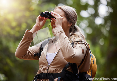 Image of Binoculars, forest explore and woman on travel journey, jungle adventure or hiking for carbon footprint holiday. Happy hiker person trekking in tropical woods or eco green environment search or watch