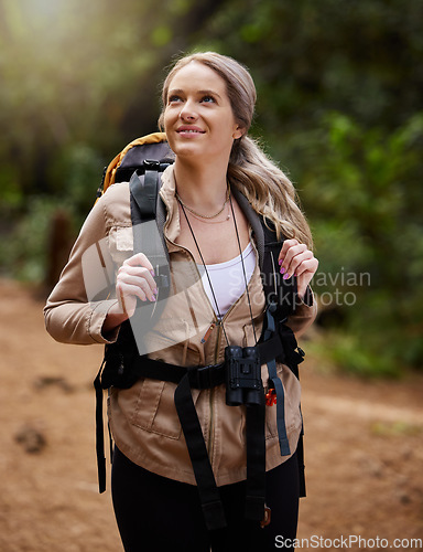 Image of Hiking, smile and forest with a woman outdoor, walking in nature or the wilderness for adventure. Freedom, thinking and woods with an attractive young female hiker taking a walk in a natural park