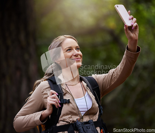 Image of Hiking, selfie or happy woman in nature, forest or wilderness live streaming trekking adventure. Pictures, social media vlogger or hiker walking in park or woods for exercise or wellness on holiday