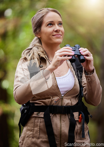 Image of Binoculars, nature and happy woman hiking for travel journey, jungle adventure and forest explore with backpack gear. Sports hiker or person birdwatching and trekking in eco, green or tropical woods