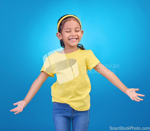 Image of Mockup, excited and girl with smile, space and celebration against blue studio background. Happy, female child or young person with open arms, happiness and fashion kid outfit with joyful or cheerful
