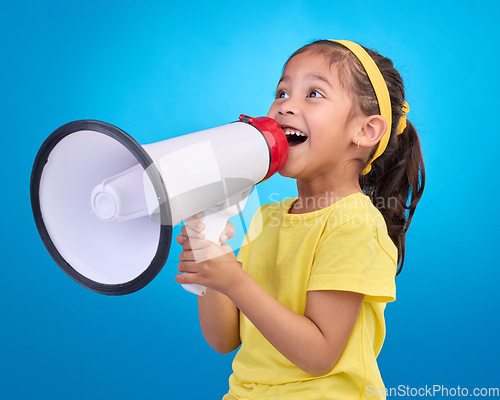 Image of Communication, speech and child with megaphone for news, opinion and announcement on blue background. Talking, speaking mockup and young girl with microphone for voice, scream and attention in studio