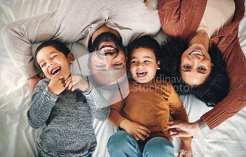 Image of Laughing, family and top view portrait on bed in bedroom, bonding and care in home. Love, smile and happy mother, comic father and funny children playing, having fun and enjoying joke time together.