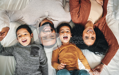 Image of Laughing, family and top view portrait on bed in bedroom, bonding and care in home. Love, smile and happy mother, comic father and funny children playing, having fun and enjoying joke time together.