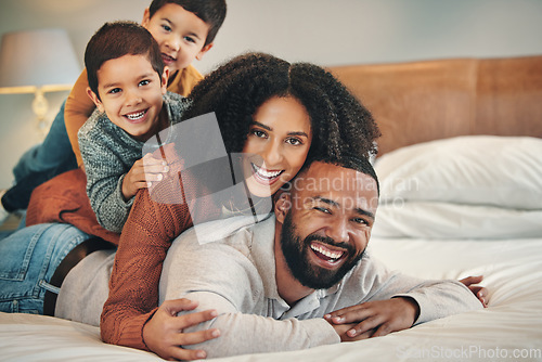 Image of Laughing, family and portrait smile on bed in bedroom, bonding and care in home. Love, comedy and happy mother, comic father and funny children playing, having fun and enjoying quality time together.