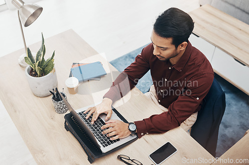 Image of Business man typing, laptop and concentrate on work, tech support with keyboard and productivity in office. Information technology, communication and male writing email or software update top view