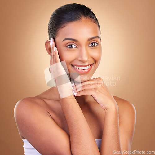 Image of Beauty, skincare and touch with portrait of indian woman in studio for happy, spa and facial. Cosmetics, self care and glow with model on brown background for satisfaction, makeup and confidence