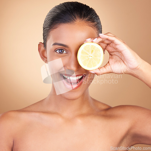 Image of Skincare, happy woman portrait and lemon for health, wellness and beauty of a young model. Studio, smile and healthy fruit with vitamin c benefits and fruits nutrition for facial and dermatology