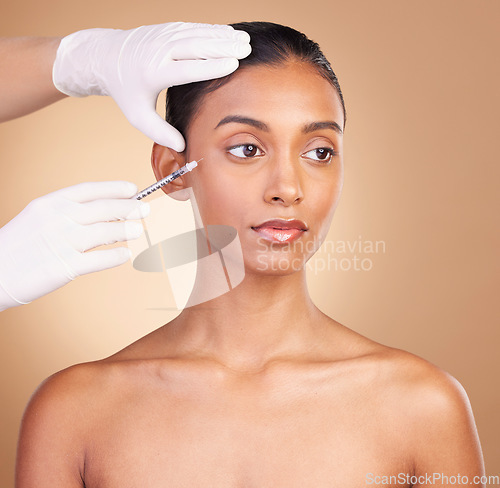 Image of Woman, face and needle with beauty and dermatology, skincare with plastic surgery on studio background. Female, hands and skin injection, cosmetic procedure with facelift treatment and eyes closed