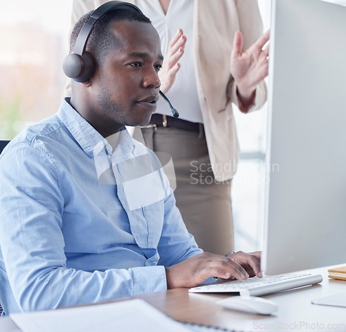 Image of Black man, call center and coach by computer for training in telemarketing, customer service or support at office. African American male intern consultant working on desktop PC with mentor in sales