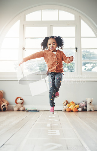 Image of Hopscotch, happy and girl play in home having fun, enjoying games and relax in bedroom. Childhood, kindergarten and excited child balance for jumping game, playing and entertainment activity on floor