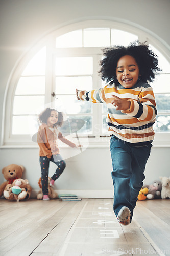 Image of Hopscotch, happy and children play in home having fun, enjoy games and relax together in room. Childhood, entertainment and excited siblings in bedroom for jumping game, playing and activity