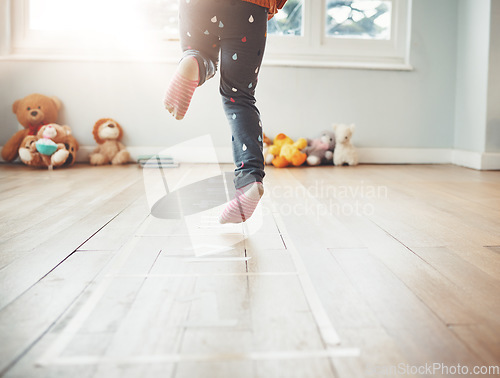 Image of Hopscotch, happy and feet of child play in home having fun, enjoying games and entertainment in room. Childhood, kindergarten and excited girl in bedroom for jumping game, playing and floor activity