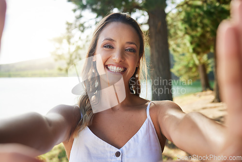 Image of Nature, happy and woman taking a selfie in the forest while on outdoor adventure alone on a weekend trip. Happiness, smile and portrait of female taking picture in woods on travel holiday or vacation