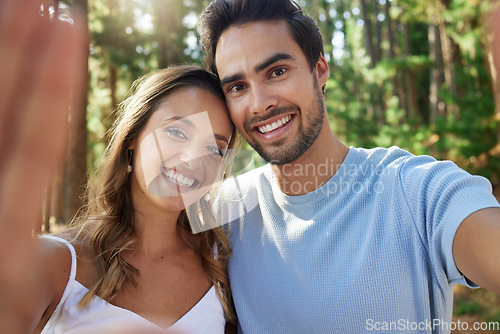 Image of Selfie, happy and portrait of a couple in nature for bonding, quality time and a memory. Smile, looking and a young man and woman taking a photo while on a date in the forest or woods together