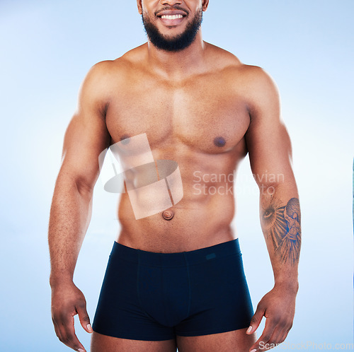 Image of Black man in underwear, fitness and body with abs, healthy and active, muscle and strong on blue backgroun. Shirtless male, exercise and bodybuilder, bare abdomen and workout with smile in studio