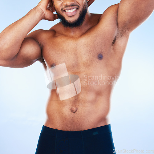 Image of Black man, fitness and body, smile and abs, healthy and active with muscle and strong on blue background. Shirtless male, exercise and bodybuilder with bare abdomen, workout and wellness in studio