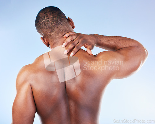 Image of Black man, neck pain and injury with fitness and health, medical problem and aching body with back view. Emergency, muscle tension and male athlete with joint ache from workout on blue background