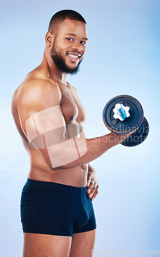 Image of Black man, exercise and weightlifting, dumbbell and biceps muscle training, smile in portrait on blue background. Health, strong and power, male flexing arms and bodybuilder with underwear in studio