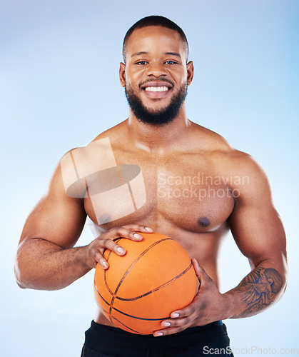 Image of Basketball player, black man and studio portrait with smile, shirtless or happy for sports by blue background. Young fitness expert, body wellness or ball in hands for development, sport and games