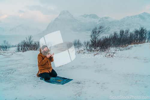 Image of A Muslim traveling through arctic cold regions while performing the Muslim prayer namaz during breaks