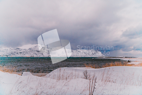 Image of Norway coast in winter with snow bad cloudy weather