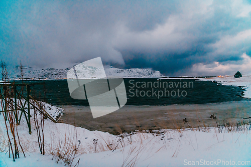 Image of Norway coast in winter with snow bad cloudy weather