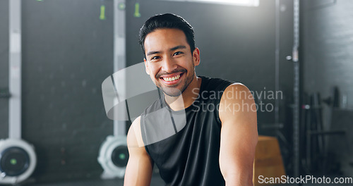 Image of Fitness, exercise and laughing with a man in a gym for a workout or training to get strong or healthy. Wellness, smile and portrait with a happy young male athlete in a health club for exercising