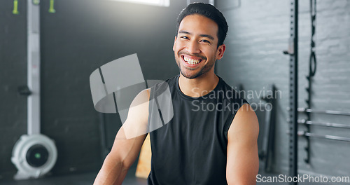 Image of Fitness, exercise and laughing with a man in a gym for a workout or training to get strong or healthy. Wellness, smile and portrait with a happy young male athlete in a health club for exercising