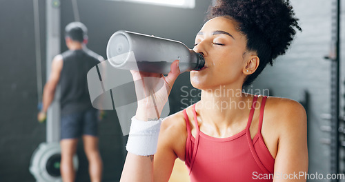 Image of Water, tired and woman thinking after fitness, training and exercise for body motivation at the gym. Drink, bottle and face of a young girl at a club for wellness, workout and cardio with an idea