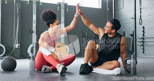 Image of High five woman, personal trainer man for fitness goal in gym or training facility together. Success, black woman motivation or friends at wellness workout, exercise support or partnership for health