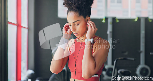 Image of Black woman, breathe and earphones for music with fitness and exercise ready in gym, health and active motivation. Start, workout and calm for body training and endurance, wellness and listening.