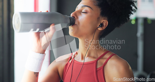 Image of Water, tired and woman thinking after fitness, training and exercise for body motivation at the gym. Drink, bottle and face of a young girl at a club for wellness, workout and cardio with an idea