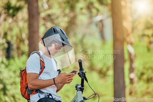 Image of Relax, phone and fitness with man on mountain bike for training, communication and contact. Technology, sports and workout with male athlete in nature for cycling, social media and travel app