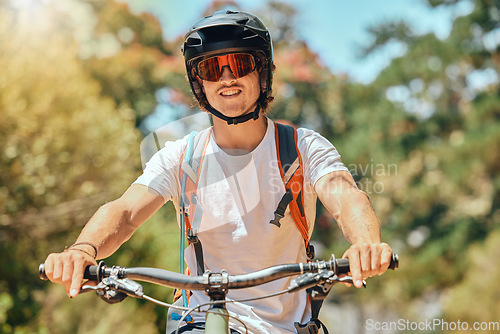 Image of Cycling, fitness and portrait of man on mountain bike for extreme sports, adventure and adrenaline junkie. Happy, smile and training with male athlete in nature for cardio endurance, race and action