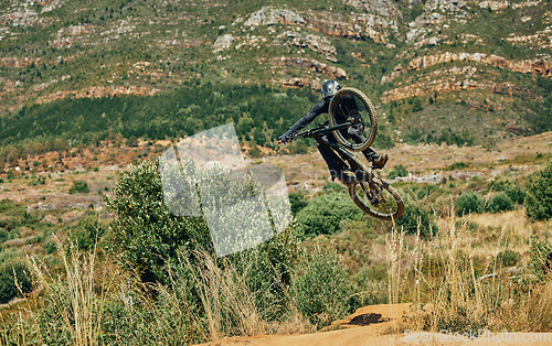 Image of Jump, extreme sports and mountain bike with man in nature for cycling, fitness and adventure. Adrenaline junkie, performance and stunt with athlete riding in outdoors for action, risk and training