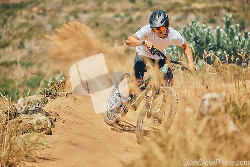 Image of Extreme sports, cycling and man on bicycle in the countryside for fitness, stunt and freedom. Nature, biking and sporty male cyclist training, practice and speed, action and free on Mexico dirt road