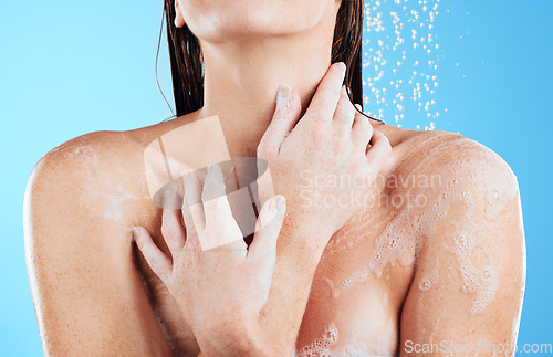 Image of Shower, woman hands and body cleaning in a studio with a female washing for beauty routine. Water, model and wellness of a young person in bathroom for self care and dermatology with blue background